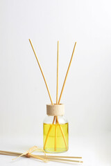 Fototapeta na wymiar Close up, air freshener with thin wooden sticks on white background.