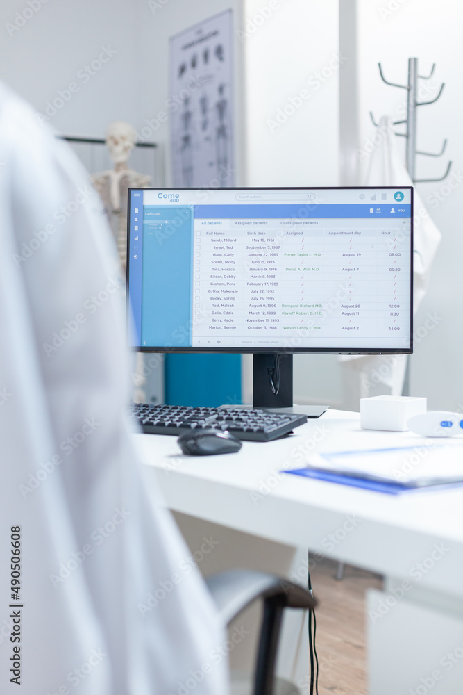 Aufkleber computer with medical patients examination document on screen standing on table in empty doctors off