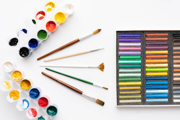 Flat composition set of artistic tools. Brushes, paints, pencils, pastels for drawing. Place for text.