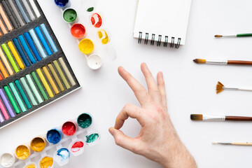 Flat composition set of artistic tools. Brushes, paints, pencils, pastels for drawing. Place for text.