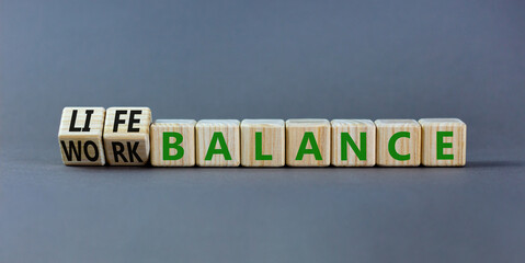 Work life balance symbol. Turned wooden cubes and changed concept words Work balance to Life balance. Beautiful grey table grey background. Business work life balance concept. Copy space.