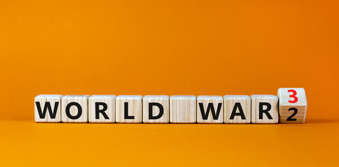WW3 world war 3 symbol. Turned the wooden cube and changed the concept word World War 2 to World War 3. Beautiful orange table orange background, copy space. Business WW3 world war 3 concept.