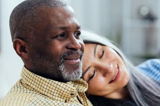 cinematic image of an happy multiethnic senior couple. Indoors Lifestyle moments at home. Concept about seniority and relationships