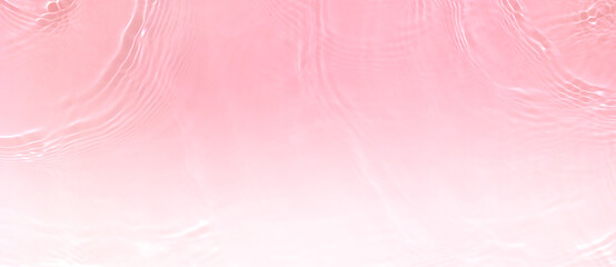 Transparent pink clear water surface texture with ripples, splashes and bubbles. Abstract summer...