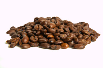 A bunch of coffee beans in close-up. roasted coffee beans on a light background
