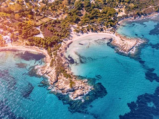Wall murals Aerial view beach Aerial view of the paradise seashore with various shades of turquoise water. Coral reefs and secluded sandy beaches in the resort village of Vourvourou in Sithonia, Halkidiki.