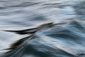 Silky abstract texture of water surface on rapid stream water flow