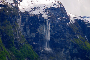 Breathtaking scenery of mountains, galciers and waterfalls in Geirangerfjord during cruising to...