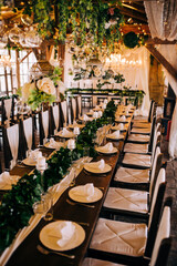 Table setting at a luxury wedding and beautiful flowers on the table.