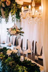 Table setting at a luxury wedding and beautiful flowers on the table.