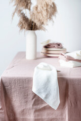 Fototapeta na wymiar Concept of romanitic Easter table with pampas and light pink tablecloth, selective focus image