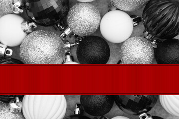 Christmas background with black and white ball ornaments with red banner
