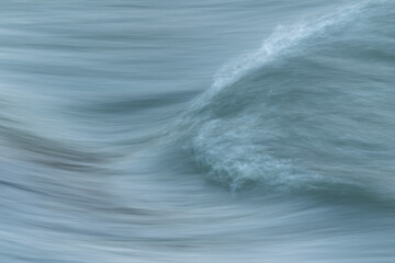 Silky water surface detail from rapid mountain stream in long exposure - abstract landscape