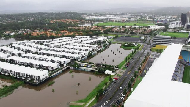 Aerial view of the QLD Floods near CBUS Stadium Robina Gold Coast QLD Australia water coming very close to house.
