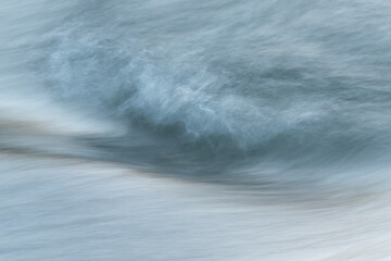 Silky water surface detail from rapid mountain stream in long exposure - abstract landscape