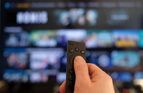 Remote control and screen - binge watching the favorite TV show