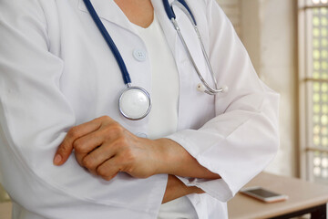 Female doctor with kindness and good wishes to hospitalized patients stands in a doctor's office.