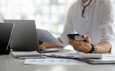 Cropped shot of businessman working, business strategy, discussing new plan financial graph data financial report investor laptop digital tablet Finance accounting investment Money Financial Concepts