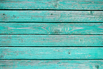 Background from old blue boards. Close-up of cracks and chips in the paint.