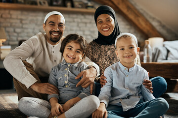 Portrait of happy Muslim family enjoys at home and looking at camera.
