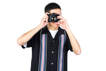 Guy using an analog camera. 35mm photographic camera. Isolated on white background. 18-20 years old latin american guy.