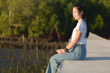 Asian woman sitting in the park 