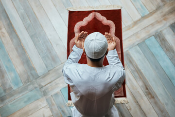 Above view of Muslim man in a prayer at mosque.