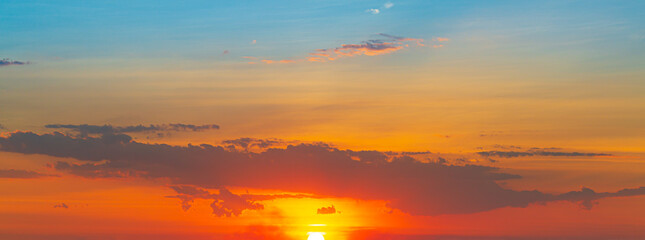 clouds and orange sky,Real amazing panoramic sunrise or sunset sky with gentle colorful clouds. Long panorama, crop it