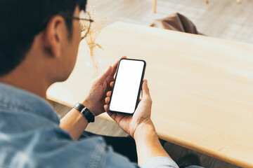 cell phone blank white screen mockup.hand holding texting using mobile on desk at office.background empty space for advertise.work people contact marketing business,technology