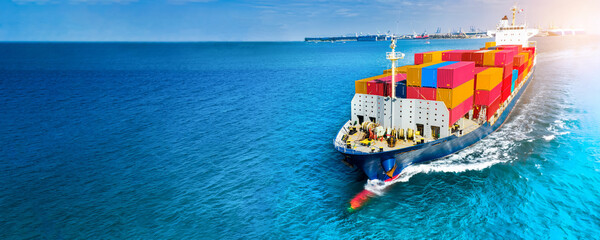 Aerial side view of cargo ship carrying container and running on blue sea for export  goods  from ...