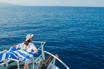 woman with greece flag at cruise boat lefkada island