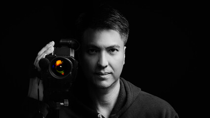 black and white portrait of asian cameraman, journalist, reporter holding camcoder. isolated on...
