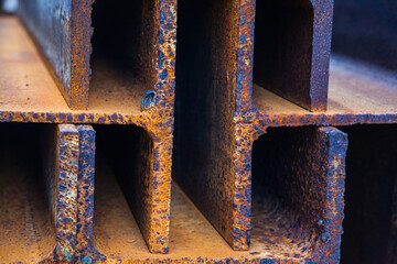Rusty steel I-beams, side view of the slice, close-up.