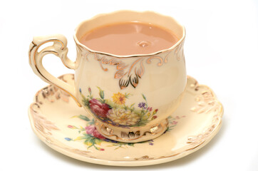 Tea with milk in a porcelain cup
