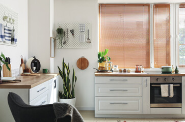 Interior of light kitchen with modern counters
