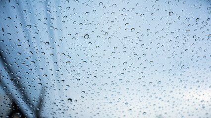 Rain drops on the windshield of the car.wetness in the rainy season.
protection against rain background with water drops on car windshield
high quality windshield.The background gives a lonely mood.