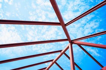 Roof trusses for homes.
metal roof construction.
The metal roof that has been painted anti-rust coating beautiful sky.Beautifully welded metal frame.Building house profession.Background industrials.