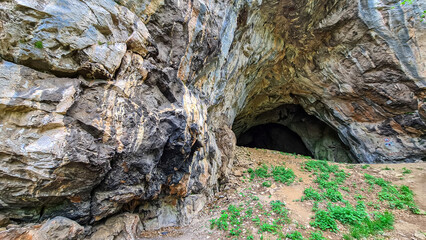 View on the entrance of the Drachenhoehle (Dragon Cave) in Pernegg an der Mur in Styria, Austria. Cave near mount Rothelstein in Mixnitz in the Grazer Bergland. Grotto, Europe. Hiking trail.