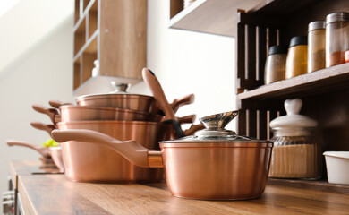 Fototapeta na wymiar Shiny saucepan on counter in modern kitchen, closeup