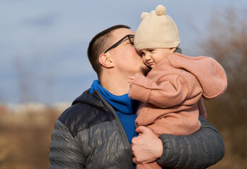 Man and his little daughter outdoor in the park