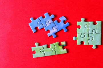 jigsaw puzzle pieces in red background, vibrant colours photography