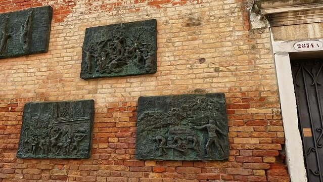 Panning view of memorial wall at Jewish ghetto quarter of Cannaregio in Venice, Italy