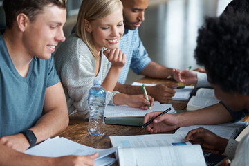 Youre making this look too easy. A group of college students sitting together and studying.