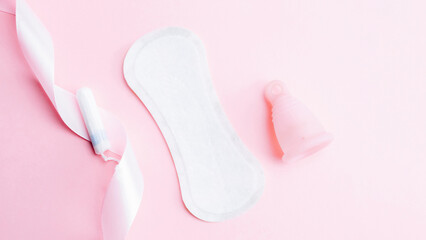 Menstrual cup, tampon, woman cup for sanitary protection. Pink ribbon with menstrual cup. Menstruation feminine period. Zero waste concept, ecofriendly lifestyle, reduced banner consumption.