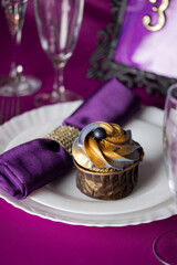 Pink and purple decoration and cupcakes on the table