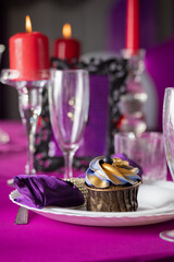 Pink and purple decoration and cupcakes on the table
