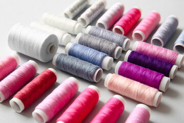 Thread spools on light background, closeup
