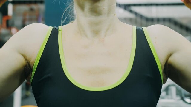 Fit Athletic Woman Exercises with Dumbbell. Muscular Women Training in Modern Gym. Sports People Workout in Fitness Center. Bodypositive Girl with Beautiful Hairy Armpits. Sweat smell.