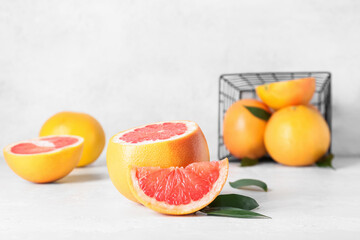 Fresh grapefruit pieces on light background