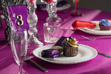 Pink and purple decoration and cupcakes on the table